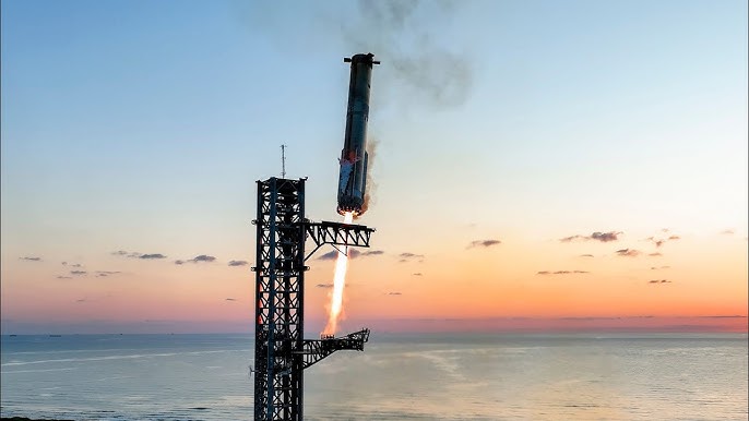 A rocket booster descending onto its launch tower’s catch arms at sunset.